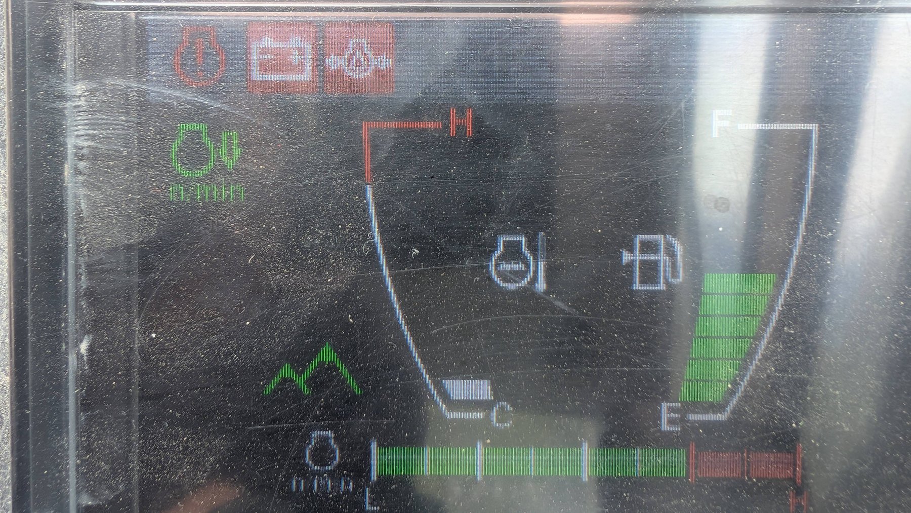 Machine cab display with an Isuzu engine: red engine and battery warning lights, coolant temperature, fuel and engine speed gauges