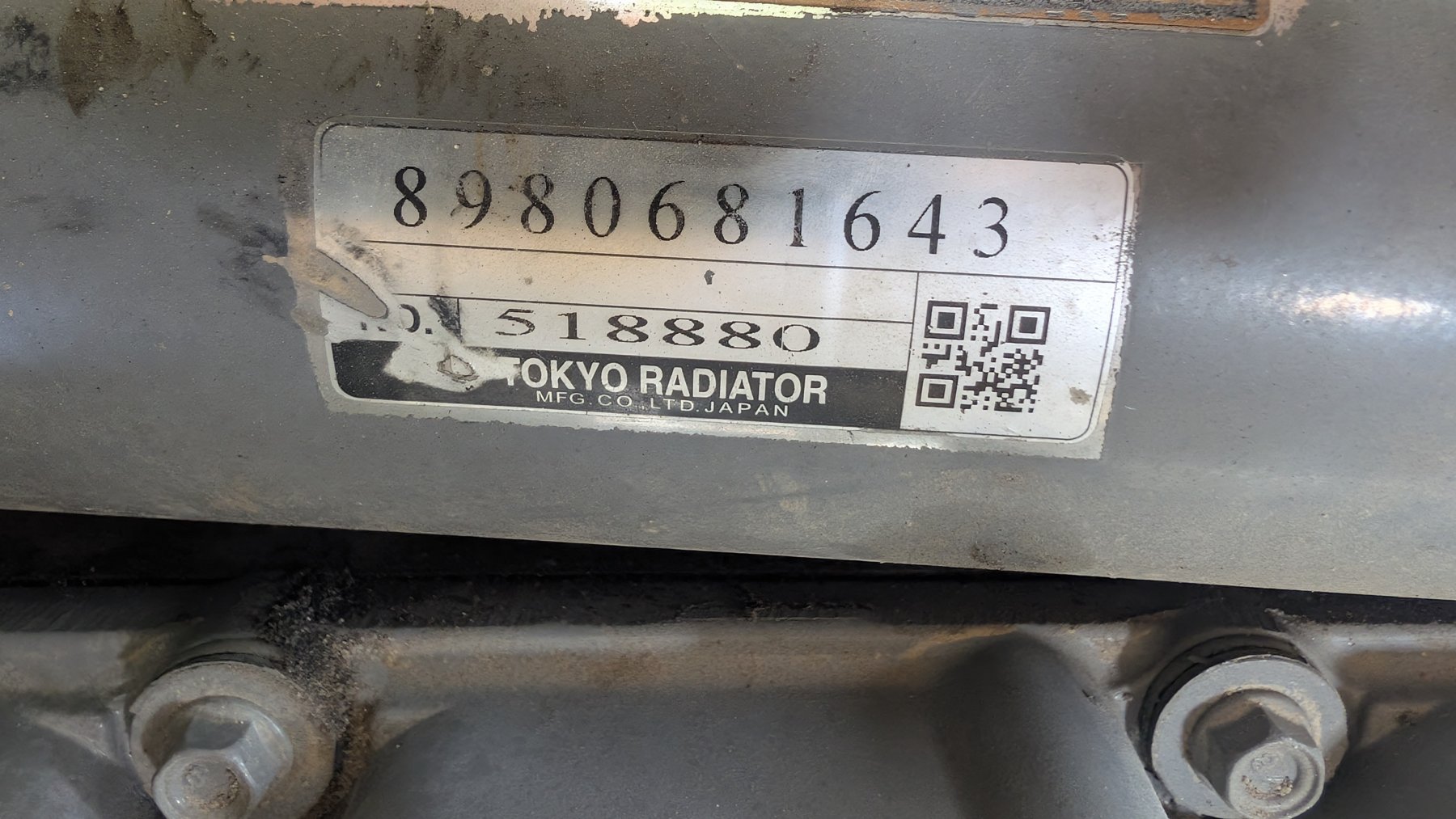 Tokyo Radiator Mfg. Co. Ltd. Japan radiator label with number 8980681643 in a machine with an Isuzu engine